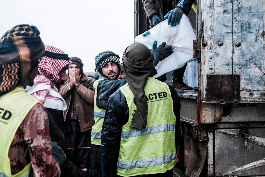 Local community members distribute aid items