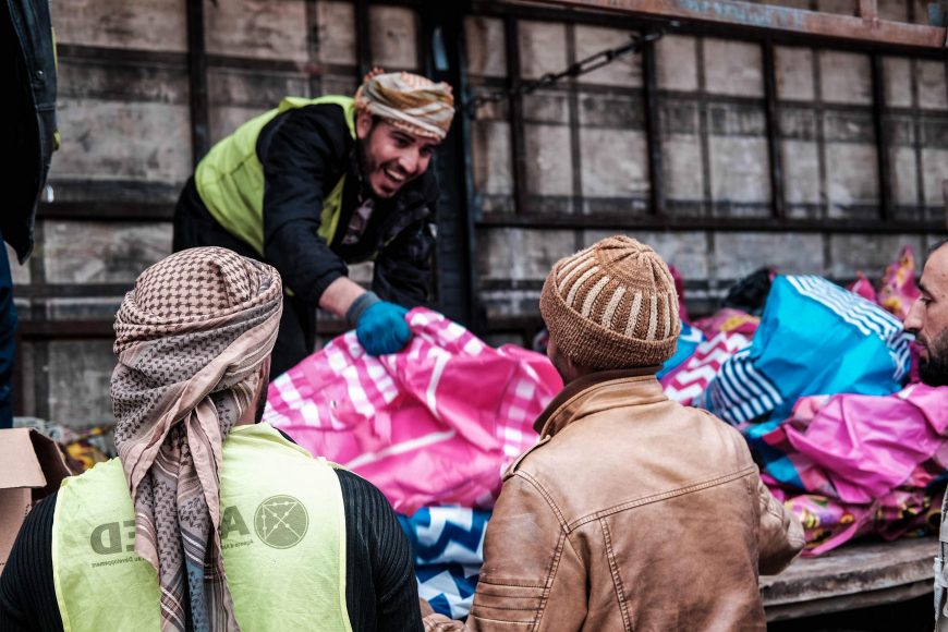 Local community members distribute aid items