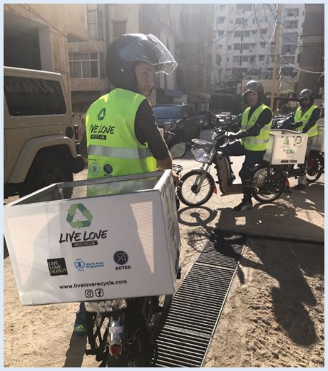 Bassel sits on his bike in the streets of Beirut waiting for a pick-up request.