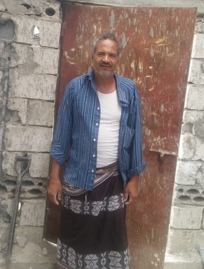 Beneficiary standing outside his house in Arashy, Yemen