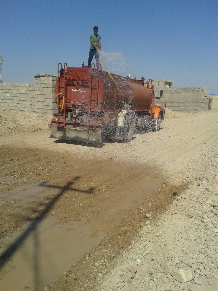 Truck wetting the road